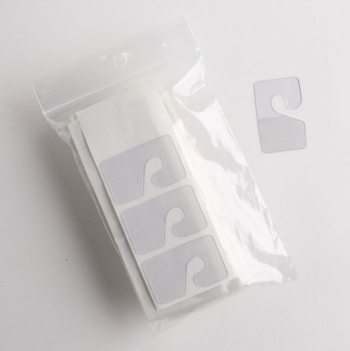 Details about   100 Self-Stick Clear Hang Tabs Tags Slatwall Hook Retail Package Hangers 